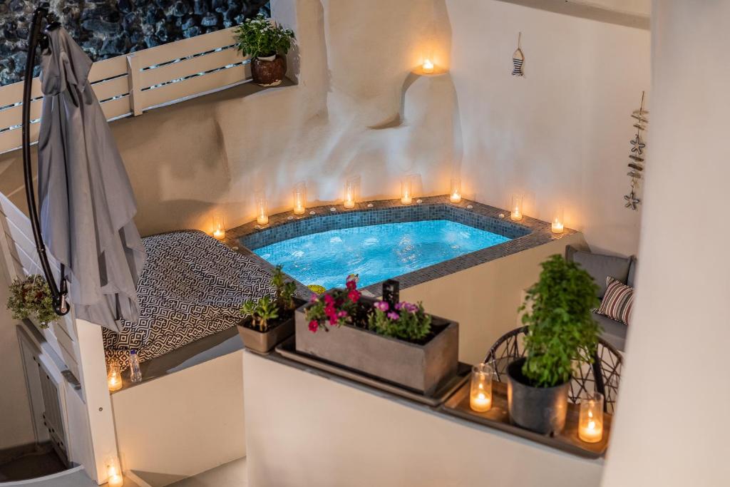 a swimming pool on a balcony with lights and plants at Hidden Treasure Suites in Vóthon