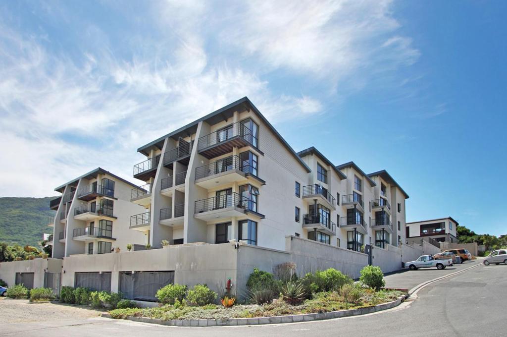 a large white apartment building on the side of a street at G Zero 3 @ The Breakers in Hout Bay