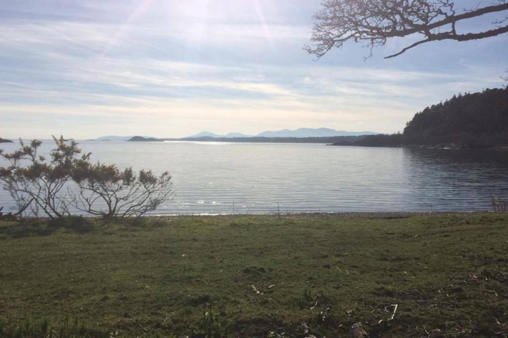 a view of a lake with mountains in the distance at Coachmans Bothy - 50m from the beach in Port Appin