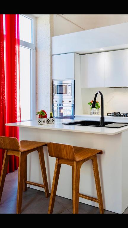 Kuchyňa alebo kuchynka v ubytovaní Ortigia Fab Apartment