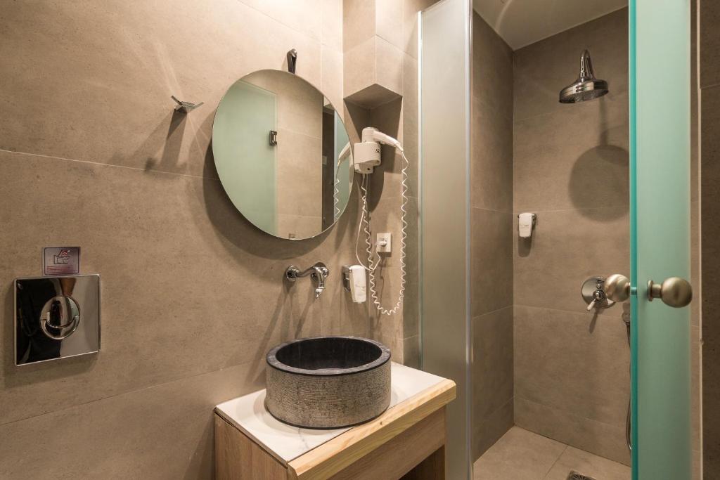 a bathroom with a sink and a mirror at Livikon by the Sea in Hora Sfakion