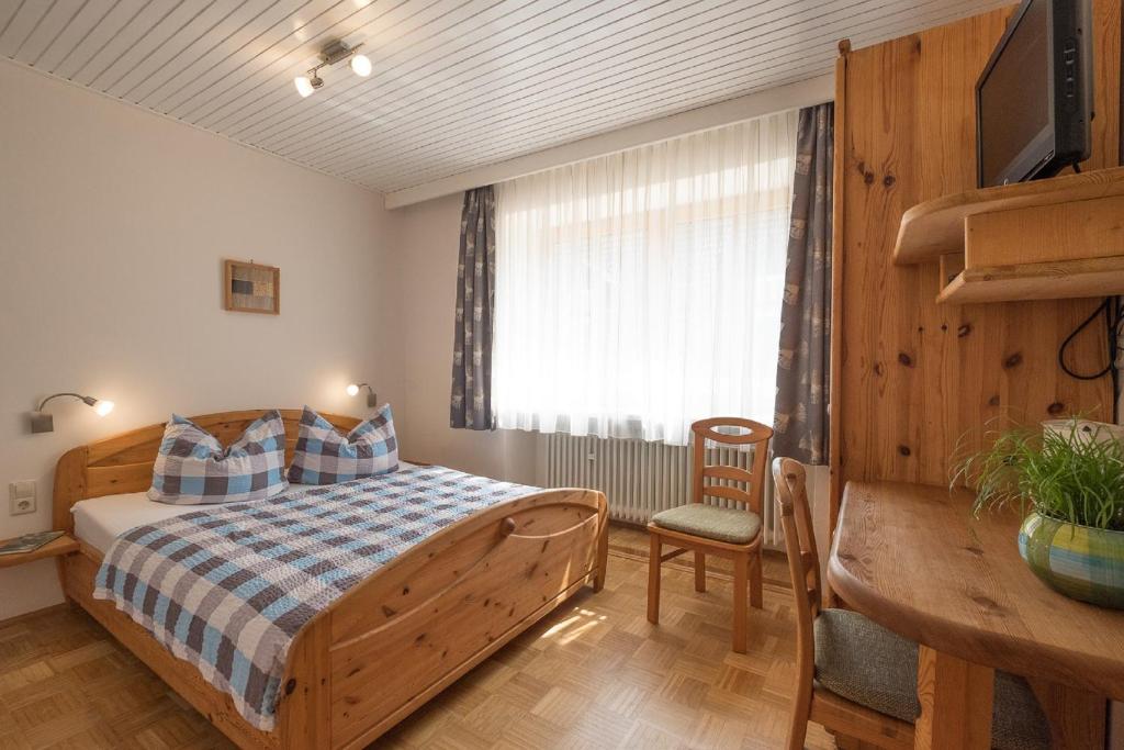 a bedroom with a bed and a table and a desk at Schelterhof in Wunsiedel