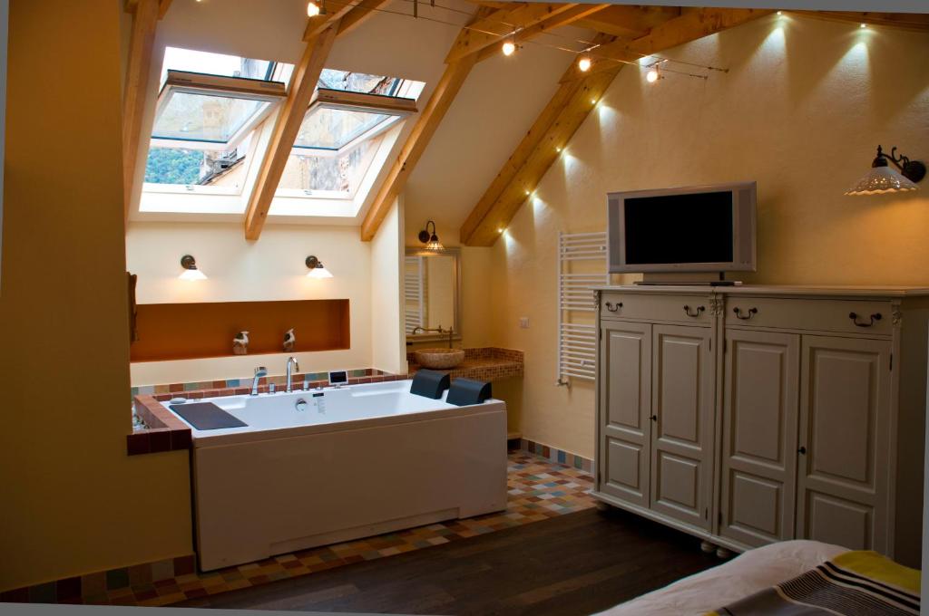 ブラショヴにあるArina Apartmentsの洗面台と壁掛けテレビ付きのバスルーム