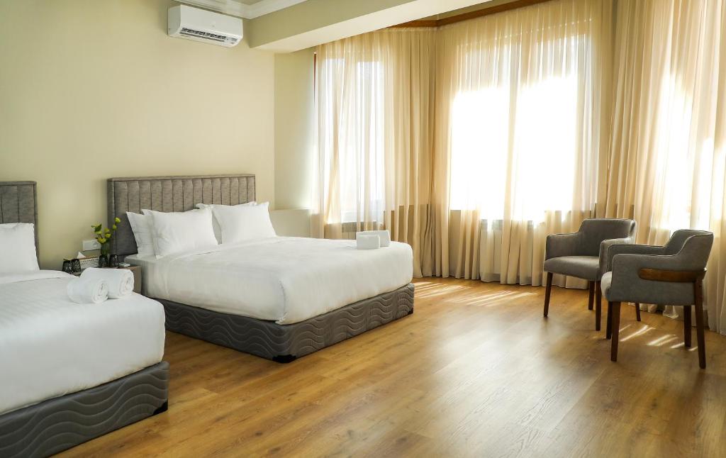 Postel nebo postele na pokoji v ubytování Teryan Pushkin Apart Hotel