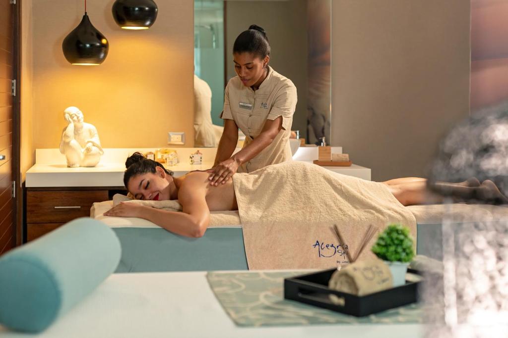 a woman getting a massage in a spa salon at Catalonia Santo Domingo in Santo Domingo