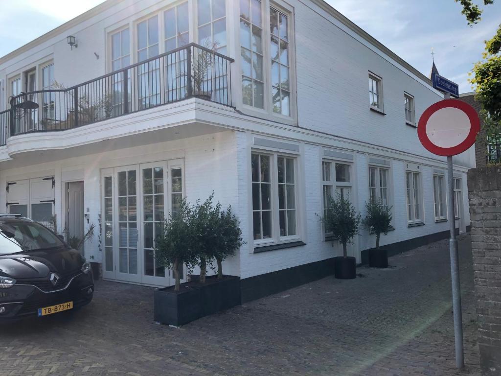 a white building with potted plants in front of it at casa Heemskerk in Noordwijk