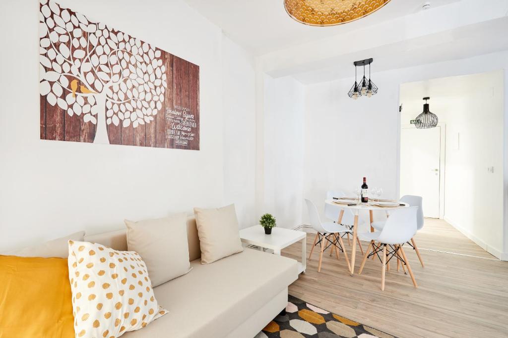 a white living room with a white couch and a table at La Casa De Esme ll in Haro