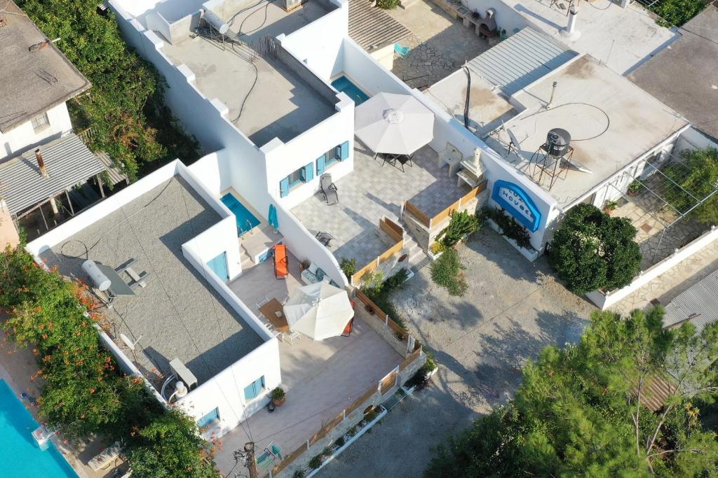 an overhead view of a white house with a pool at Tanyas Cozy House in Kamilari