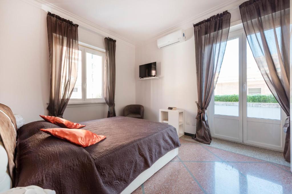 ein Schlafzimmer mit einem Bett und einem großen Fenster in der Unterkunft Dream House spazioso appartamento tra Policlinico e Piazza Bologna in Rom