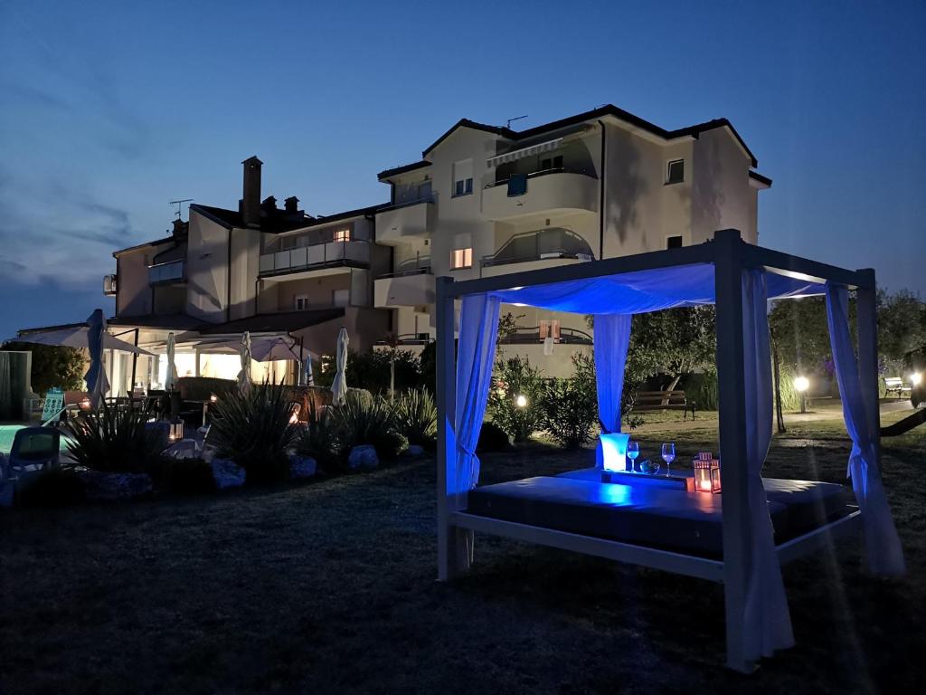 a gazebo in front of a house at night at Villa Badi in Umag