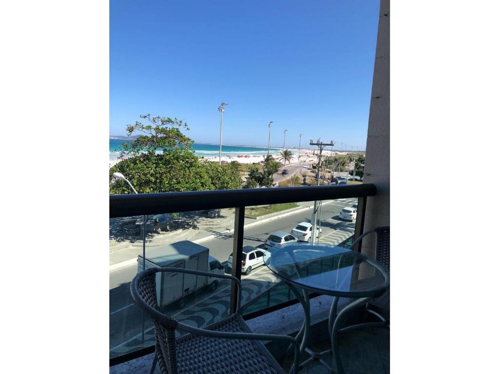 a balcony with chairs and a view of the beach at FORTE DA PRAIA 2 in Cabo Frio