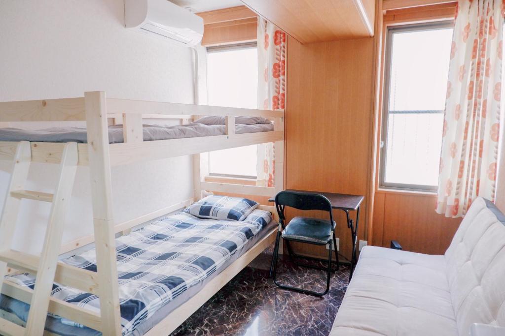 Postel nebo postele na pokoji v ubytování 匯金浅草一号館