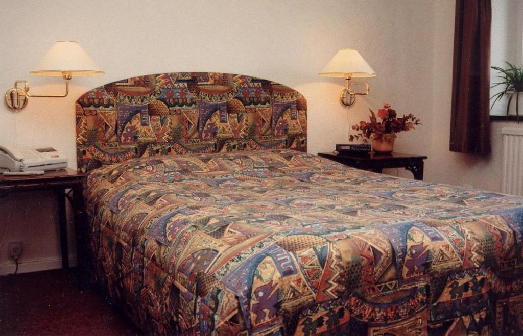 Postel nebo postele na pokoji v ubytování Hotel Chaplin