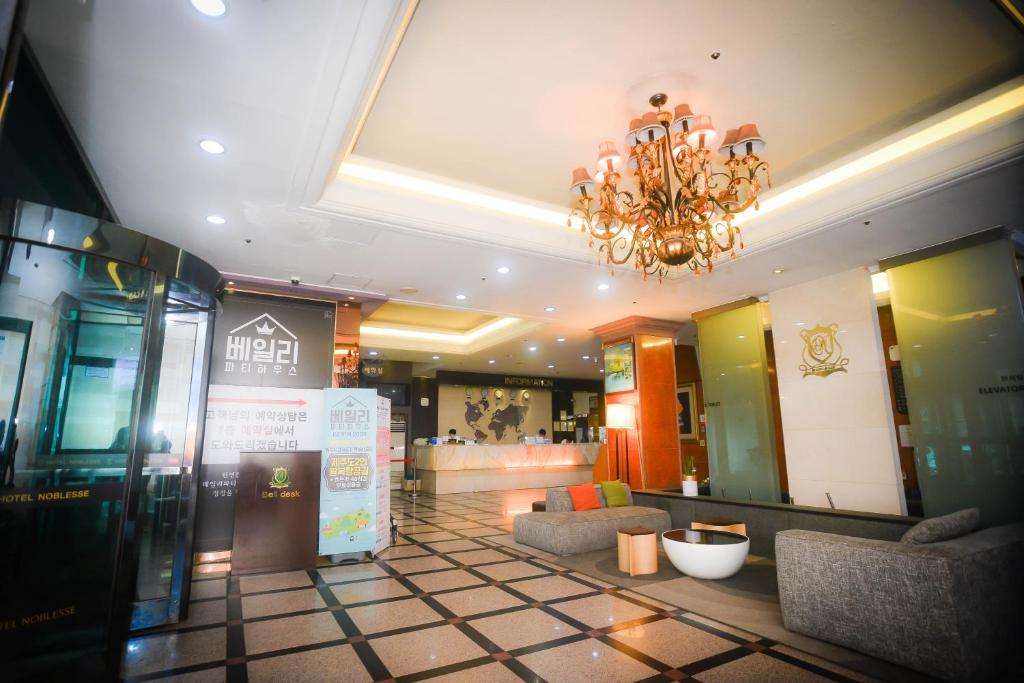 a lobby of a store with a chandelier at Hotel Noblesse in Seoul