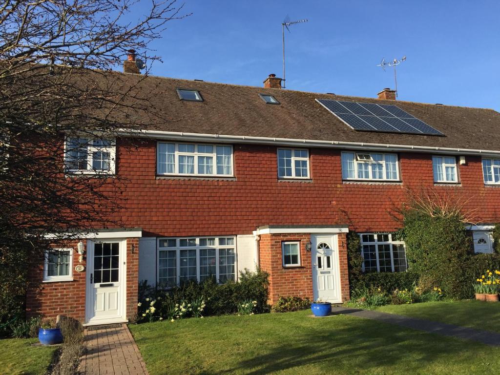 a red brick house with solar panels on the roof at New Forest Brockenhurst in Brockenhurst