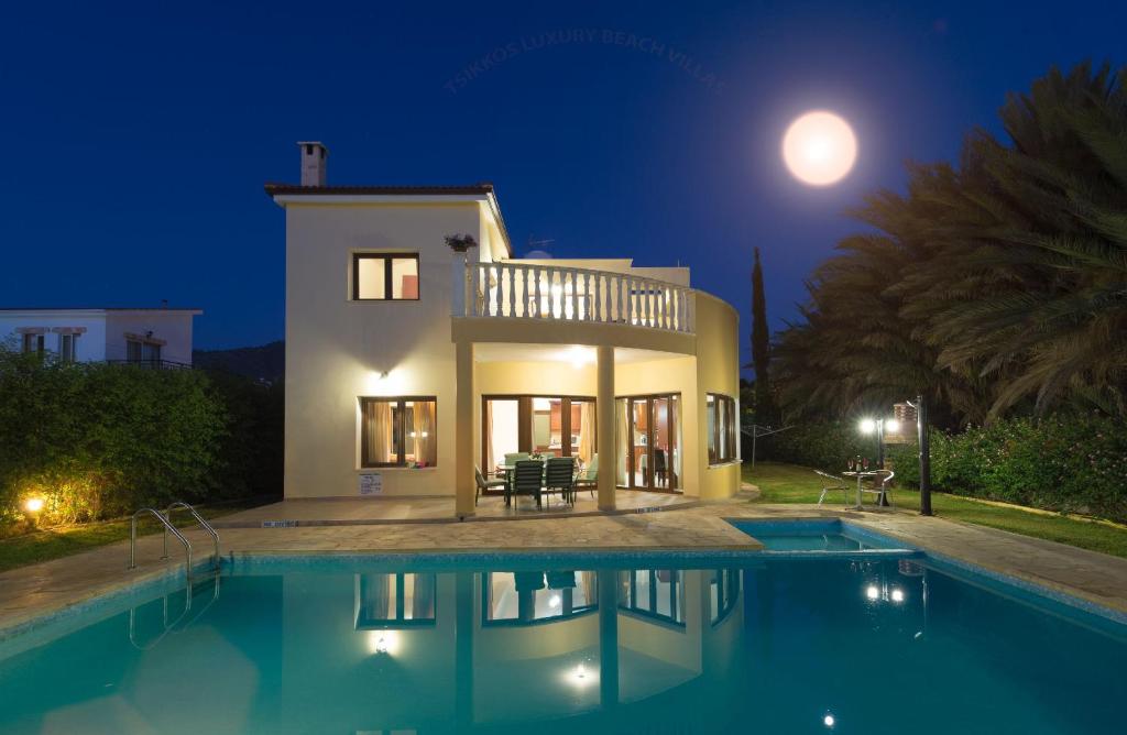 a villa with a swimming pool at night at Villa Tsikkos Tria in Polis Chrysochous