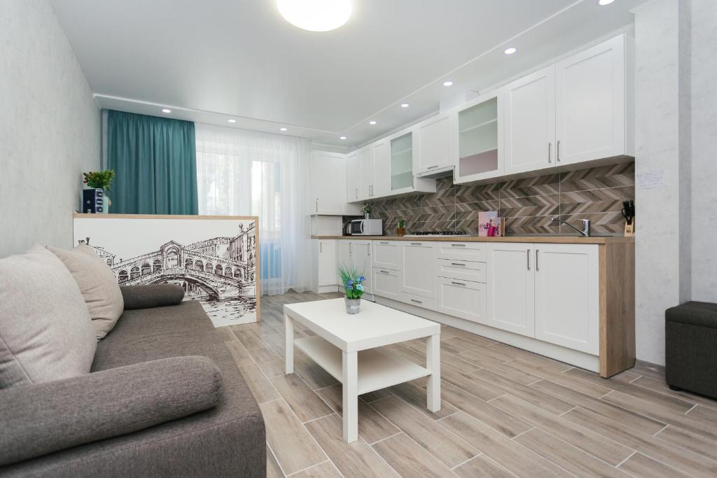 a living room with a couch and a table at Luxury apart-hotel on Kharkovskaya near Lavina 1 floor in Sumy