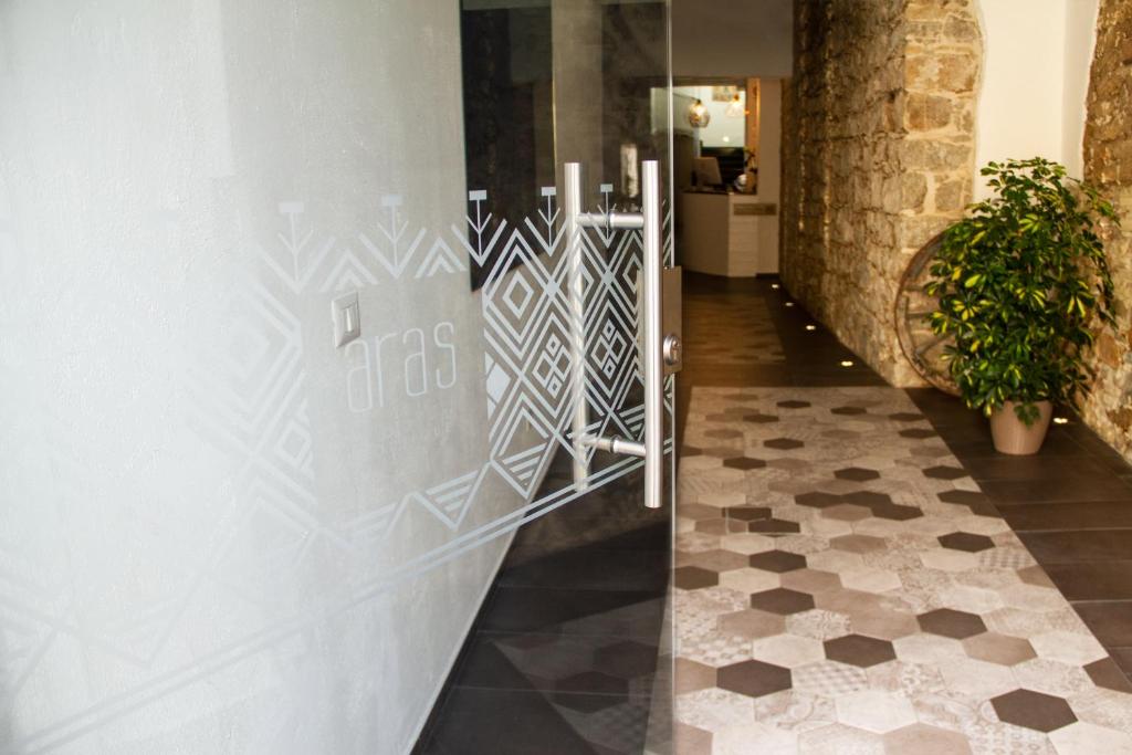 Aras Hotel Boutique في فيلاسيميوس: ممر مع باب وأرضية من البلاط