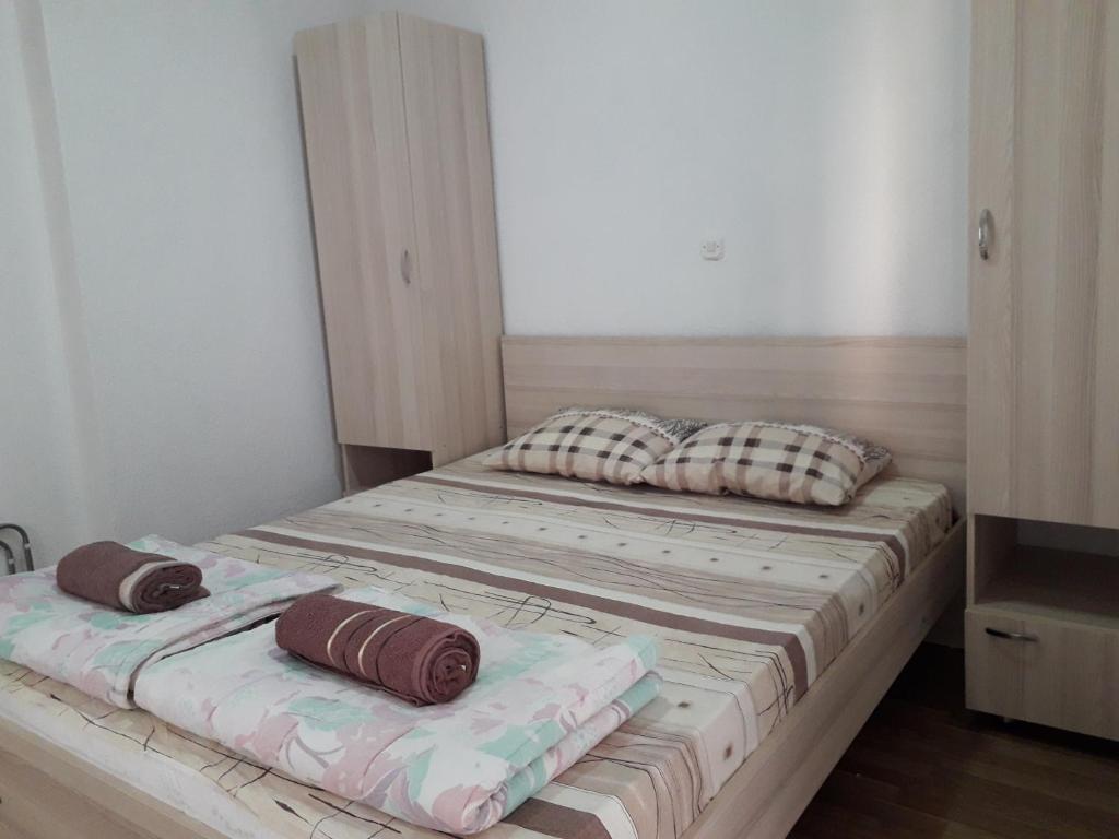 a bed with two pillows on it in a room at Ristevski Apartment in Bitola