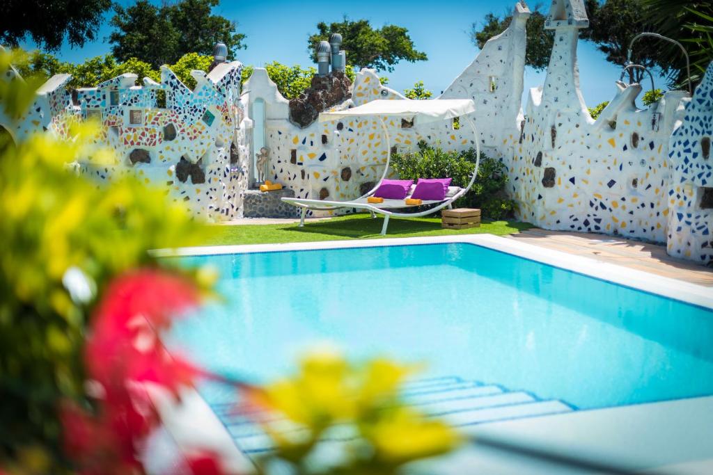 a swimming pool in a backyard with a white fence at Los MOXAICOS, TENERIFE in Costa Del Silencio