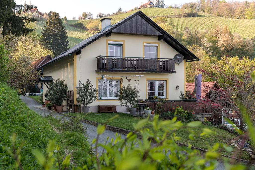 a house in a vineyard with a hill at Privatzimmer Haring in Kitzeck im Sausal