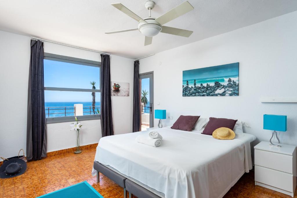 a bedroom with a bed with a view of the ocean at Stunning Beachclose Villa by Costarentals - Ref 03 in Fuengirola