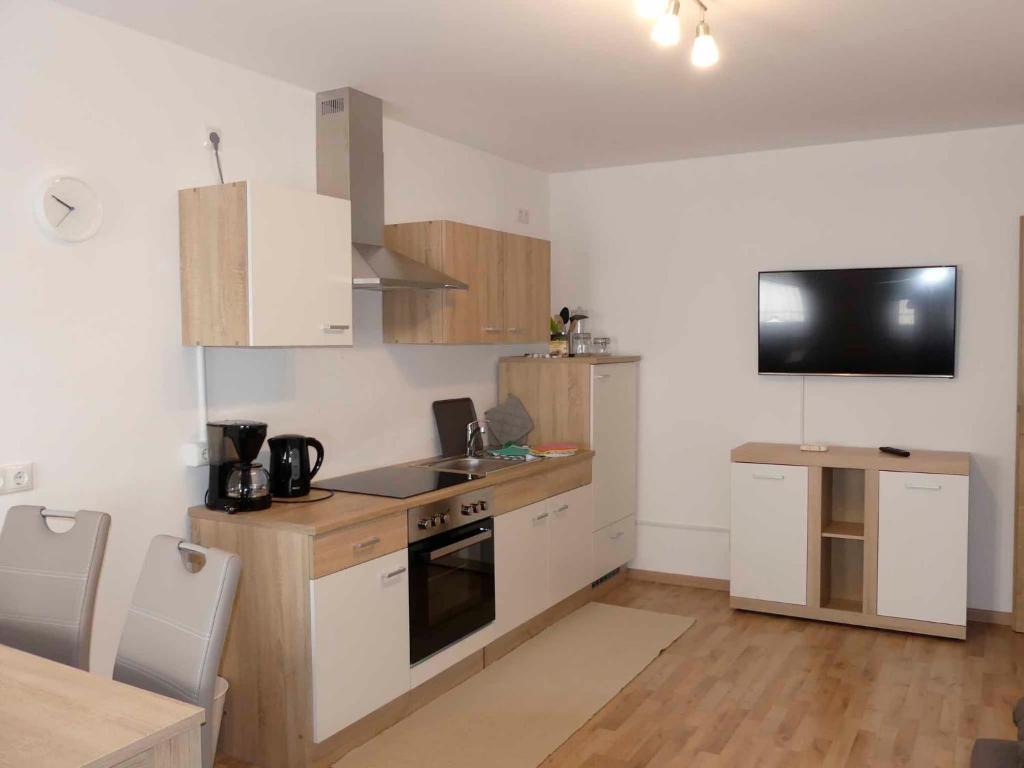 a kitchen with a sink and a stove top oven at FeWo Zum Kuhturm in Günzburg