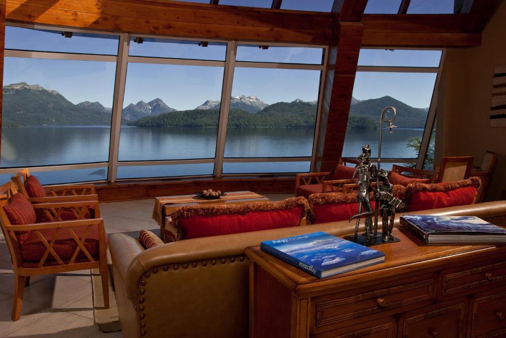 a living room with a view of a lake at Sol Arrayan Hotel & Spa in Villa La Angostura