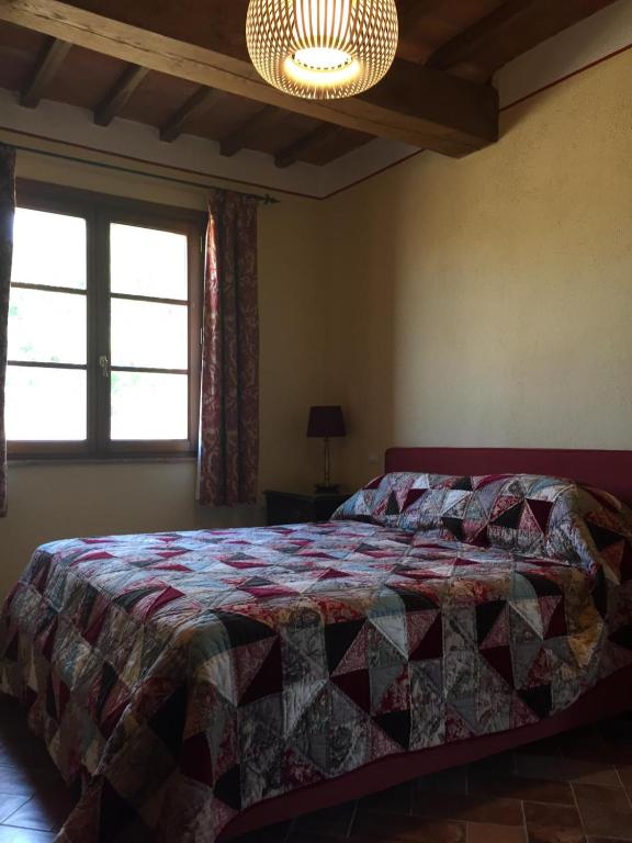 Postel nebo postele na pokoji v ubytování Podere dell'Alloro