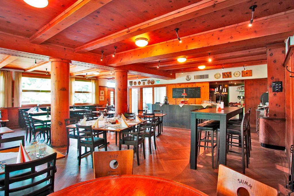 a dining room with tables and chairs in a restaurant at Gasthaus zur Waldegg in Luzern