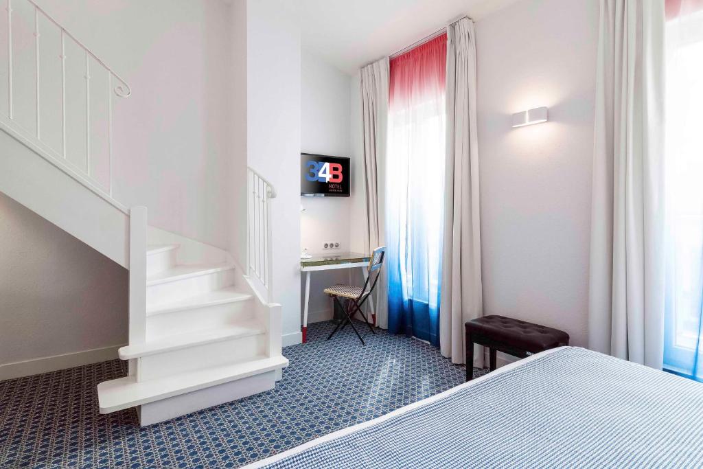 a hotel room with a bed and a television at Hotel 34B - Astotel in Paris