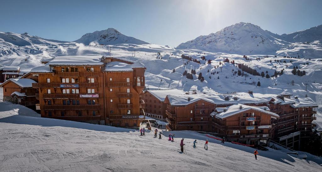 a group of people standing on a snow covered mountain at Hôtel Les Balcons Village in Belle Plagne