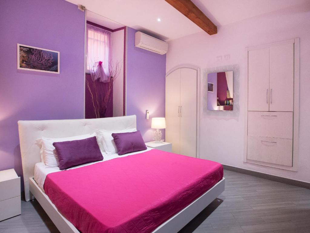 Postel nebo postele na pokoji v ubytování I Coralli rooms & apartments