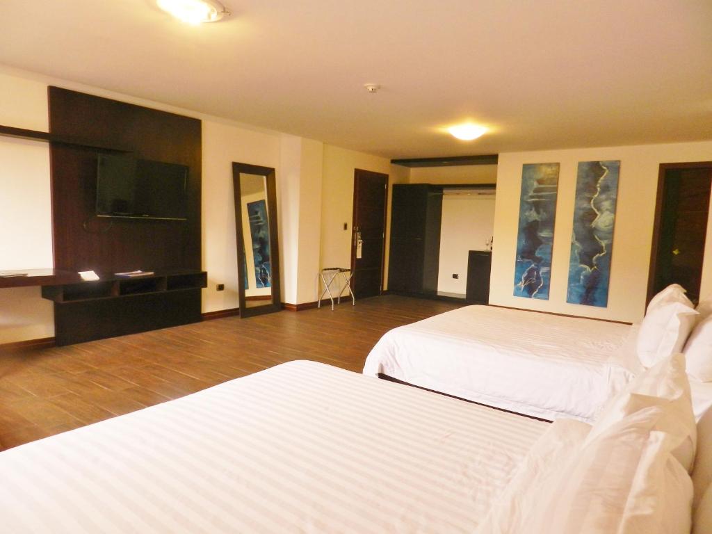 Postel nebo postele na pokoji v ubytování Arhaná Hosteria & Resort