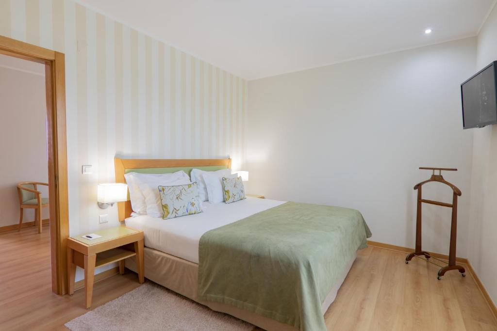 Кровать или кровати в номере Luna Esperanca Centro Hotel
