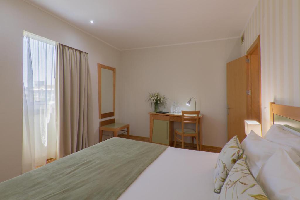 Кровать или кровати в номере Luna Esperanca Centro Hotel