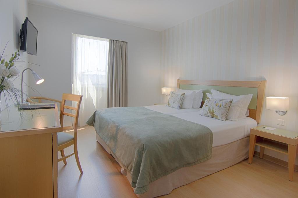Кровать или кровати в номере Luna Esperanca Centro Hotel