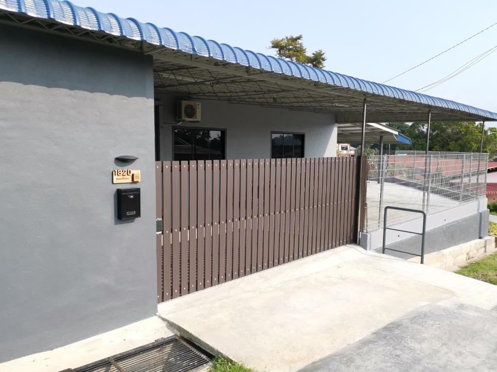 a building with a gate with a ramp next to it at Aqua Shelter in Mersing