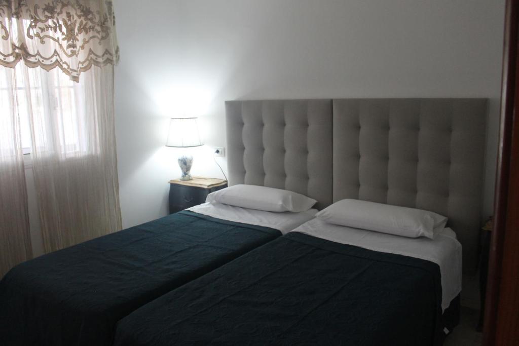A bed or beds in a room at Magnifico apartamento en las dunas de corralejo