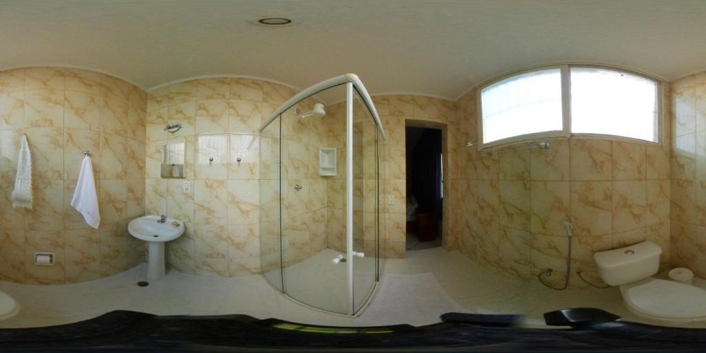 a bathroom with a shower and a sink at Pousada Convento Da Penha in Vila Velha