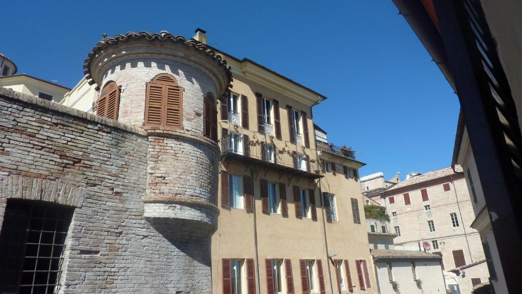 a building with a clock tower on the side of it at Al Pergolesi B&B in Iesi
