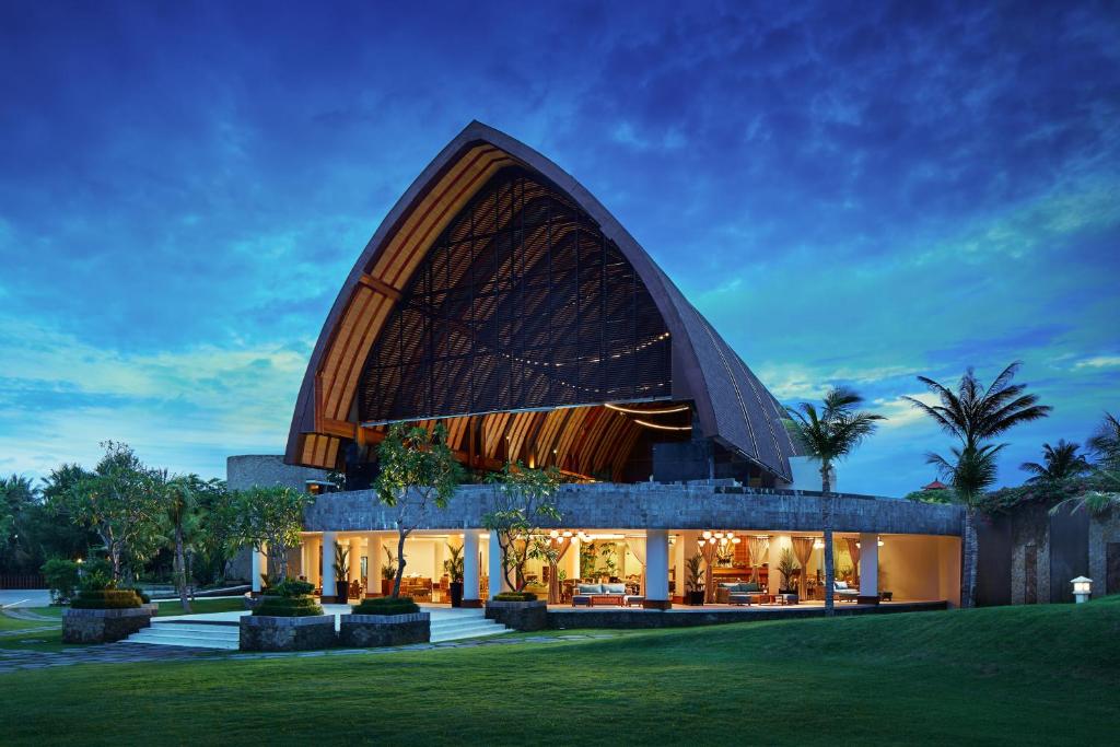 a large building with a large curved roof at MERUSAKA Nusa Dua in Nusa Dua