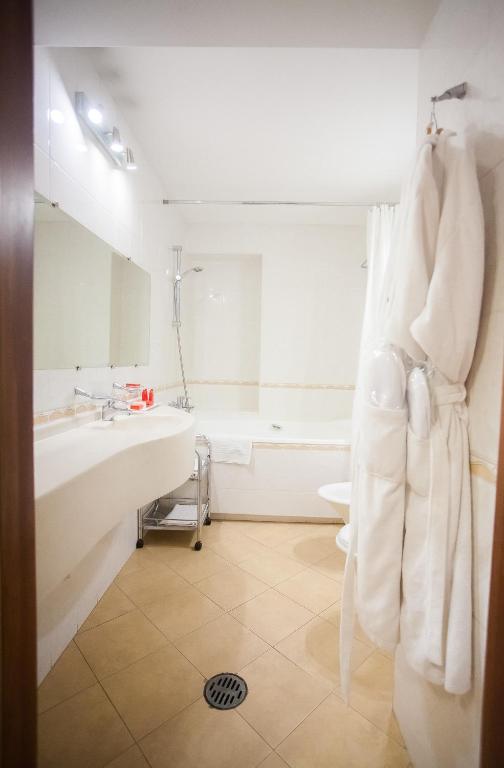 a bathroom with a sink and a bath tub at AZIMUT Hotel Siberia in Novosibirsk