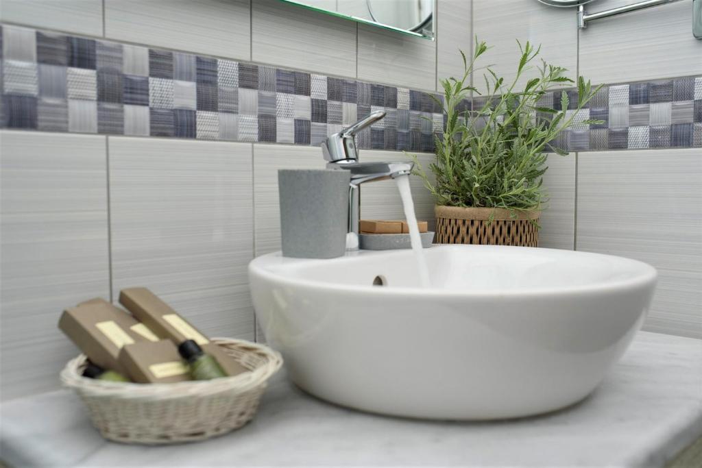 a bathroom sink with a faucet on a counter at Vigla Hotel in Aegiali