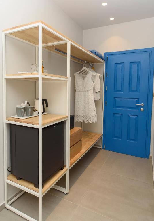 a walk in closet with a blue door at Vigla Hotel in Aegiali