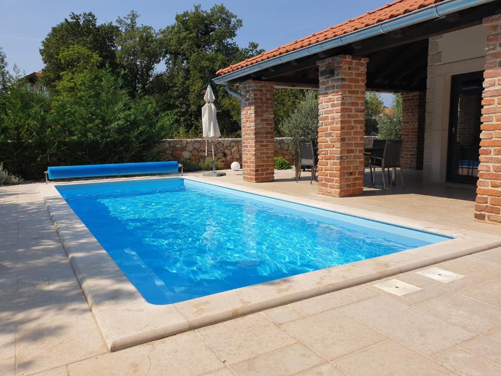 einen Pool in einem Hof mit einem Haus in der Unterkunft Villa Kvarner in Krk