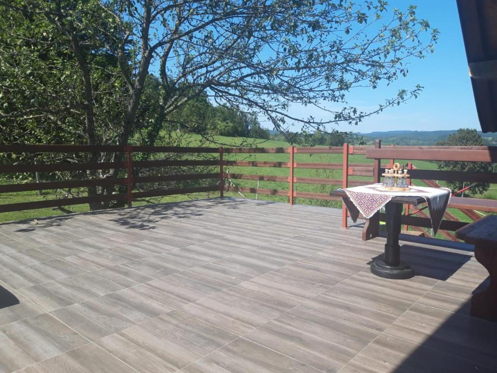 a patio with a table and a fence at Holiday Apartman Ravna Dolina in Cetingrad