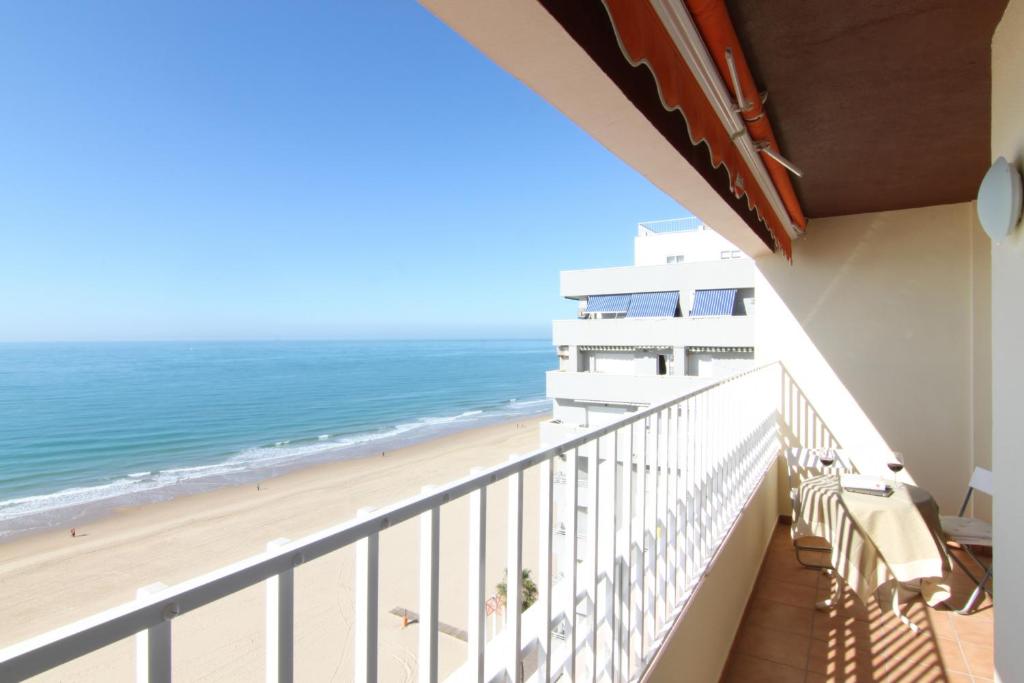 a balcony with a view of the beach at Apartamento Playa Victoria Cadiz in Cádiz