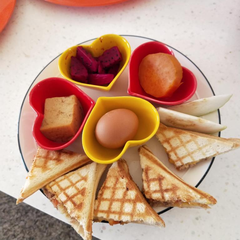 a plate of food with crackers and other snacks at Full Moon Resort in Hengchun