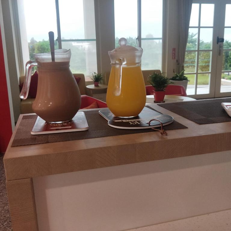 two glass vases sitting on a counter with drinks at Full Moon Resort in Hengchun